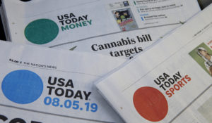 Sections of a USA Today newspapers rest together, Monday, Aug. 5, 2019, in Norwood, Mass. (AP Photo/Steven Senne)