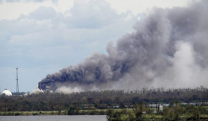 A fire at BioLab Inc., a chemical plant that handles chlorine for swimming pools, burns on Thursday, Aug. 27, 2020, in Westlake, La., in the aftermath of Hurricane Laura. (AP Photo/Gerald Herbert)