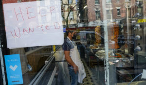 A help wanted sign hangs in the window of a restaurant in the Greenwich Village neighborhood of Manhattan in New York, Tuesday, May 4, 2021.  (AP Photo/Mary Altaffer)