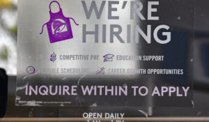 Now hiring signs are posted in window of local Taco Bell in Emporia, Kansas, as businesses look to hire employees and increase normal production after the pandemic. (Mark Reinstein/MediaPunch /IPX)