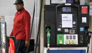 A man leaves a Murphy Oil gas station as pumps are seen out of gas, Tuesday, May 11, 2021, in Kennesaw, Ga. Colonial Pipeline, which delivers about 45% of the fuel consumed on the East Coast, halted operations last week after revealing a  cyberattack that it said had affected some of its systems.(AP Photo/Mike Stewart)