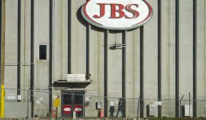 A worker heads into the JBS meat packing plant Monday, Oct. 12, 2020, in Greeley, Colo. (AP Photo/David Zalubowski)