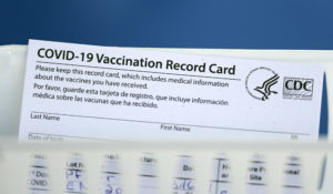 A vaccination record card is shown during a COVID-19 vaccination drive for Spring Branch Independent School District education workers Tuesday, March 16, 2021, in Houston. (AP Photo/David J. Phillip)