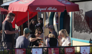 In this March 31, 2021 file photo, people eat and drink outdoors on a patio  in Santa Monica, Calif. (AP Photo/Damian Dovarganes, File)