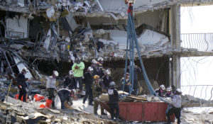 Crews work in the rubble at the Champlain Towers South Condo, Sunday, June 27, 2021, in Surfside, Fla. Many people were still unaccounted for after Thursday's fatal collapse. (AP Photo/Wilfredo Lee)