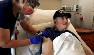 World War II veteran John Mohun, 94, receives a COVID-19 vaccination at the Veterans Affairs agency in Phoenix on Tuesday, Dec. 16, 2020. (Dexter Marquez/Veterans Affairs via AP)