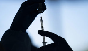 In this Jan. 21, 2021 file photo, a medical staff member prepares the Pfizer COVID-19 vaccine at Tudor Ranch in Mecca, Calif. (AP Photo/Jae C. Hong, File)