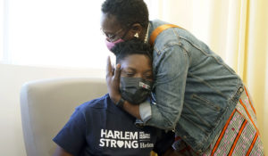 Julian Boyce, 14, gets a hug from his mother, Satrina Boyce, after he received his first Pfizer COVID-19 vaccination dose at NYC Health + Hospitals/Harlem, in New York, on May 13, 2021. Vaccination campaigns in the U.S. and parts of Europe are ushering in a period of post-lockdown euphoria, and children there are being inoculated so that they can go back to summer camp and school. (AP Photo/Richard Drew, File)