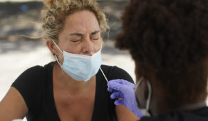 Paola Preciado gets a COVID-19 test in North Miami last week. (AP Photo/Marta Lavandier, File)