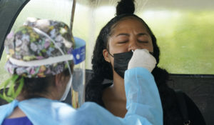 Chantel Powell gets a COVID-19 PCR test in order to travel later this week at a Miami-Dade County testing site, Monday, July 26, 2021, in Miami. (AP Photo/Marta Lavandier)
