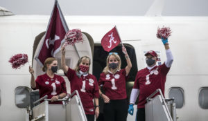 A Delta airline crew cheers after delivering the University of Alabama football team to Tuscaloosa in January 2021 following the team's national championship win. (AP Photo/Vasha Hunt)