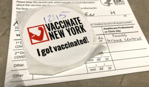 A  proof of vaccination record card and sticker at Grand Central Station in New York City. (STRF/STAR MAX/IPx)