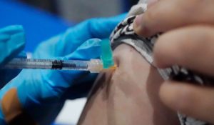 Xiaoli Su, a professor at Jackson State, holds up her sleeve as she receives a COVID-19 vaccination in Jackson, Miss. last week. (AP Photo/Rogelio V. Solis)