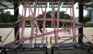 Banned public benches are taped off according to social distancing rules at a park in Anyang, South Korea, Friday, July 30, 2021. The country just detected its first two cases of a variant some are calling delta plus as it battles a fourth wave of infections. (AP Photo/Ahn Young-joon)