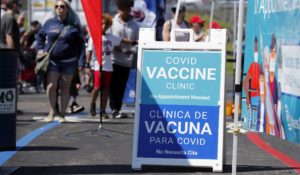 A sign for a mobile coronavirus vaccine clinic is displayed during a New England Patriots NFL football practice at Gillette Stadium, Saturday, July 31, 2021, in Foxborough, Mass. (AP Photo/Michael Dwyer)