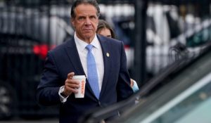 New York Gov. Andrew Cuomo prepares to board a helicopter after announcing his resignation on Tuesday. (AP Photo/Seth Wenig)