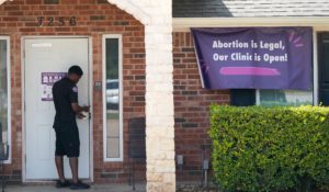 A security guard opens the door to the Whole Women's Health Clinic in Fort Worth, Texas on Wednesday. A Texas law banning most abortions in the state took effect at midnight, but the Supreme Court has yet to act on an emergency appeal to put the law on hold. (AP Photo/LM Otero)