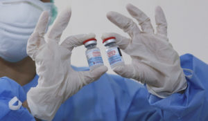 A health worker shows of Moderna COVID-19 vaccine before she give booster shots to colleagues at Adam Malik Hospital in Medan, North Sumatra, Indonesia, Wednesday, Aug. 4, 2021. (AP Photo/Binsar Bakkara)