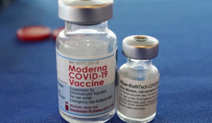Empty bottles of the Pfizer and Moderna COVID-19 vaccines await disposal by a nurse with the Jackson-Hinds Comprehensive Health Center in Jackson, Miss., Sept. 21, 2021. (AP Photo/Rogelio V. Solis)