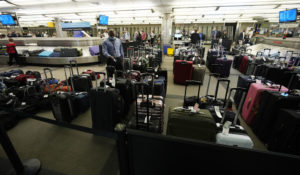 Unclaimed baggages wells up between carousels for passengers arriving on Southwest Airlines flights at Denver International Airport late Sunday, Oct. 9, 2021, in Denver. (AP Photo/David Zalubowski)
