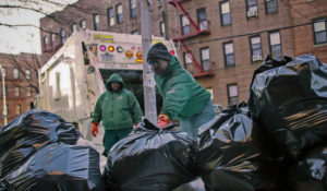 New York City sanitation workers pick up garbage in he Flatbush section of Brooklyn, N.Y., on Jan. 3, 2011. More than 26,000 of New York City’s municipal workers remained unvaccinated after Friday’s deadline to show proof they’ve gotten at least one dose of the COVID-19 vaccine. (AP Photo/Bebeto Matthews, File)