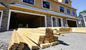 In this June 24, 2021, photo, lumber is piled at a housing construction site in Middleton, Mass. (AP Photo/Elise Amendola)