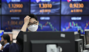 A currency trader watches monitors at the foreign exchange dealing room of the KEB Hana Bank headquarters in Seoul, South Korea, Tuesday, Nov. 30, 2021. Asian shares were mixed Tuesday as investors continued to cautiously weigh how much damage the new omicron coronavirus variant may unleash on the global economy. (AP Photo/Ahn Young-joon)