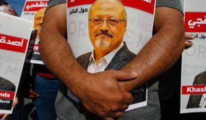 People hold posters of slain Saudi journalist Jamal Khashoggi, near the Saudi Arabia consulate in Istanbul, marking the two-year anniversary of his death in October 2020. (AP Photo/Emrah Gurel)