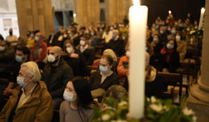 Worshippers, wearing face masks to curb the spread of COVID-19, attend a Christmas mass at the Lisbon Cathedral in the first hour of Saturday, Dec. 25, 2021. Despite vaccination rates that make other governments envious, Portugal is facing the hard truth that, with the new omicron variant running rampant, the winter holidays won't be a time of unrestrained joy. (AP Photo/Armando Franca)