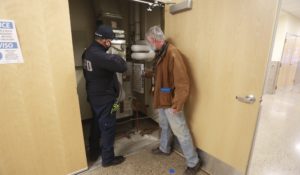 Fire and schools officials inspect an air filtration system at the Nina Otero Community School on Monday, Feb. 8, 2021, in Santa Fe, New Mexico. (AP Photo/Cedar Attanasio)