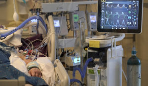 A COVID-19 patient is attached to life-support systems in the COVID-19 Intensive Care Unit at Dartmouth-Hitchcock Medical Center, in Lebanon, N.H., Jan. 3, 2022. (AP Photo/Steven Senne, File)
