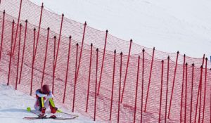U.S. skier Mikaela Shiffrin sits on the side of the course after skiing out in the first run of the women's slalom at the 2022 Winter Olympics on Wednesday. (AP Photo/Robert F. Bukaty)