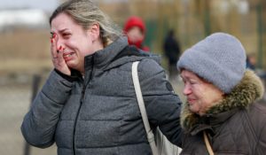 A Ukrainian woman reacts after arriving at the Medyka border crossing, in Poland on Sunday. (AP Photo/Visar Kryeziu)
