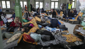 Refugees from Ukraine rest after arriving to the railway station in Przemysl, Poland, Sunday, Feb. 27, 2022.  (AP Photo/Czarek Sokolowski)