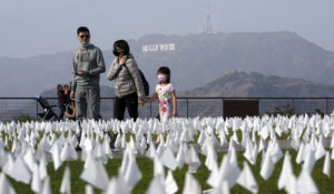 Visitors walk past a memorial for victims of COVID-19 at the Griffith Observatory, Friday, Nov. 19, 2021, in Los Angeles. (AP Photo/Marcio Jose Sanchez)