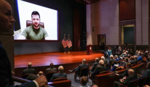 Members of Congress watch as Ukranian President Volodymyr Zelensky gives a virtual address to Congress on Wednesday. (Sarahbeth Maney/The New York Times via AP, Pool)