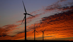 Wind turbines are silhouetted against the sky at sunset Friday, Dec. 17, 2021, near Ellsworth, Kan. The 300-foot-tall turbines are among the 134 units comprising the Post Rock Wind Farm. (AP Photo/Charlie Riedel)