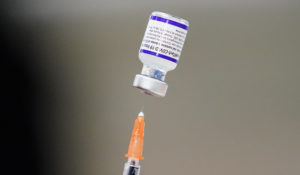A syringe is prepared with the Pfizer COVID-19 vaccine at a vaccination clinic at the Keystone First Wellness Center in Chester, Pa., on Dec. 15, 2021. (AP Photo/Matt Rourke, File)