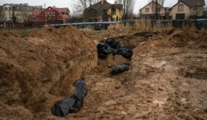 A mass grave in Bucha, on the outskirts of Kyiv, Ukraine, on Sunday. Ukrainian troops are finding brutalized bodies and widespread destruction in the suburbs of Kyiv, sparking new calls for a war crimes investigation and sanctions against Russia. (AP Photo/Rodrigo Abd)