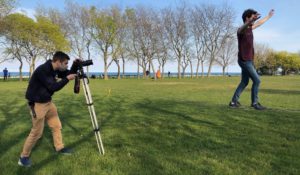 Andrew Rowan shoots b-roll of a student slacklining on the Northwestern University lakefill for a story. (Joey Safchik / Northwestern News Network)