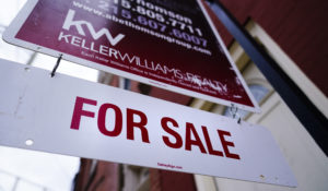 A for sale sign is posted on a home in Philadelphia, Tuesday, Jan. 18, 2022. (AP Photo/Matt Rourke)