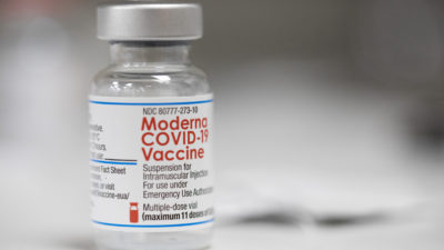 A vial of the Moderna COVID-19 vaccine is displayed on a counter at a pharmacy in Portland, Ore., Monday, Dec. 27, 2021. (AP Photo/Jenny Kane)