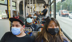 Commuters wear facemasks while riding a Metro bus in downtown Los Angeles, Tuesday, April 26, 2022. (AP Photo/Damian Dovarganes)