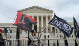 Abortion-rights protesters wave flags during a demonstration outside of the U.S. Supreme Court on Sunday. (AP Photo/Gemunu Amarasinghe)