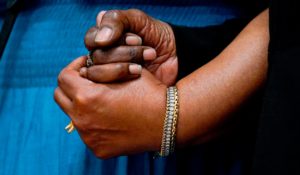 Angela Crawley, left, and Robin Harris, the daughters of Ruth Whitfield, a victim of the shooting at a supermarket, hold hands during a news conference in Buffalo on Monday. (AP Photo/Matt Rourke)