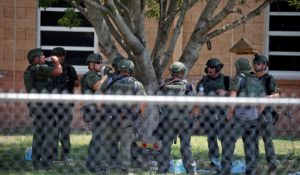 Law enforcement personnel stand outside Robb Elementary School following Tuesday’s mass shooting in Uvalde, Texas. (AP Photo/Dario Lopez-Mills)