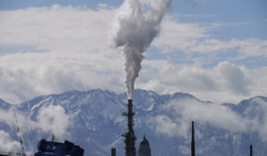 The Utah State Capitol, rear, is shown behind an oil refinery on Thursday, May 12, 2022, in Salt Lake City. (AP Photo/Rick Bowmer)