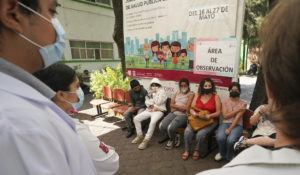 Doctors supervise children after they received their first dose of the Pfizer COVID-19 vaccine at a vaccination center in Mexico City, Friday, May 20, 2022, shortly after the capital began vaccinating children 12 years old and up against COVID-19. (AP Photo/Fernando Llano)