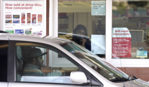 A patient gets a free drive-thru COVID-19 test at a Walgreens store in Mundelein, Ill., Thursday, Dec. 3, 2020.   (AP Photo/Nam Y. Huh)