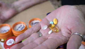 Retiree Donna Weiner shows some of the daily prescription medications that she needs and for which pays over $6,000 a year, at her home, Tuesday, Oct. 5, 2021, in Longwood, Fla. (AP Photo/Phelan M. Ebenhack)